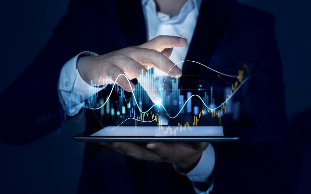 Businessman,Holding,Tablet,With,Growing,Virtual,Hologram,Of,Statistics,,Graph